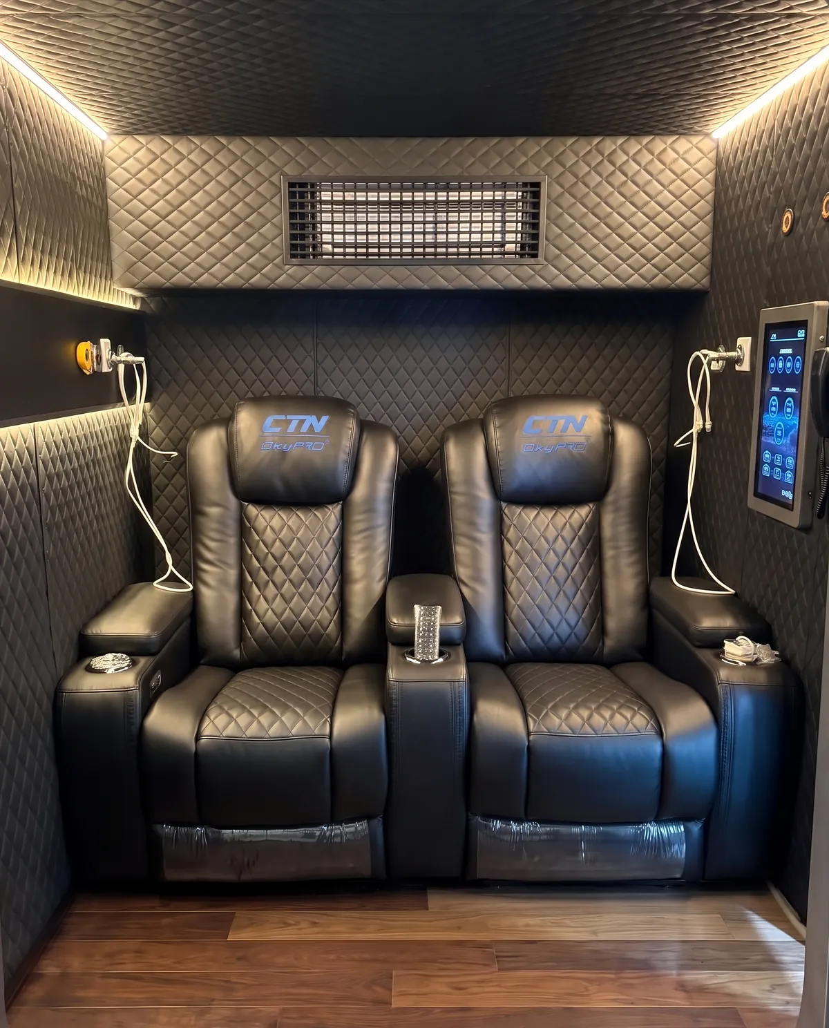 Inside the OxyPro VH2: two leather electric recliners